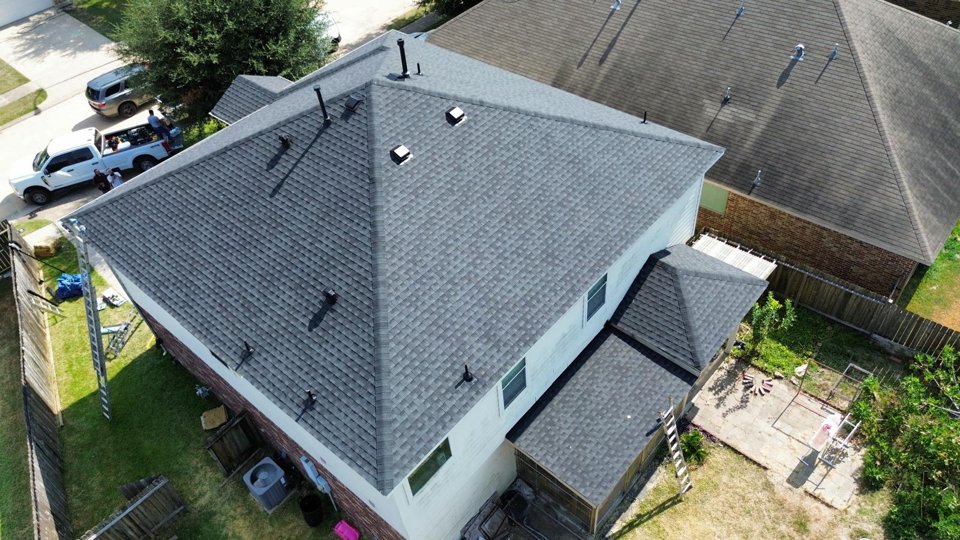 Aerial view of a house with gray roof shingles